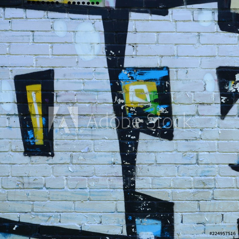 Image de Fragment of graffiti drawings The old wall decorated with paint stains in the style of street art culture Colored background texture